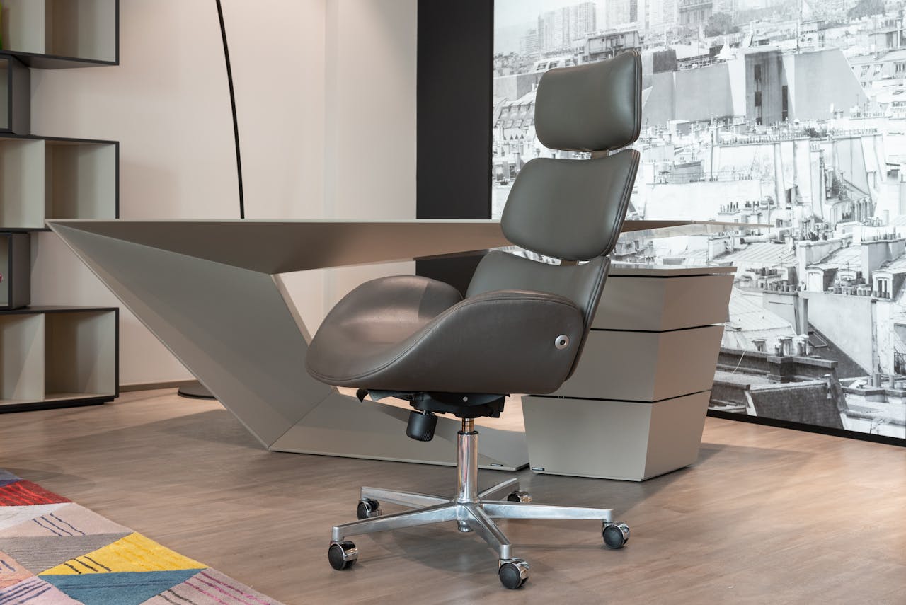 Sleek office setup with a designer chair and geometric desk in a modern workspace.